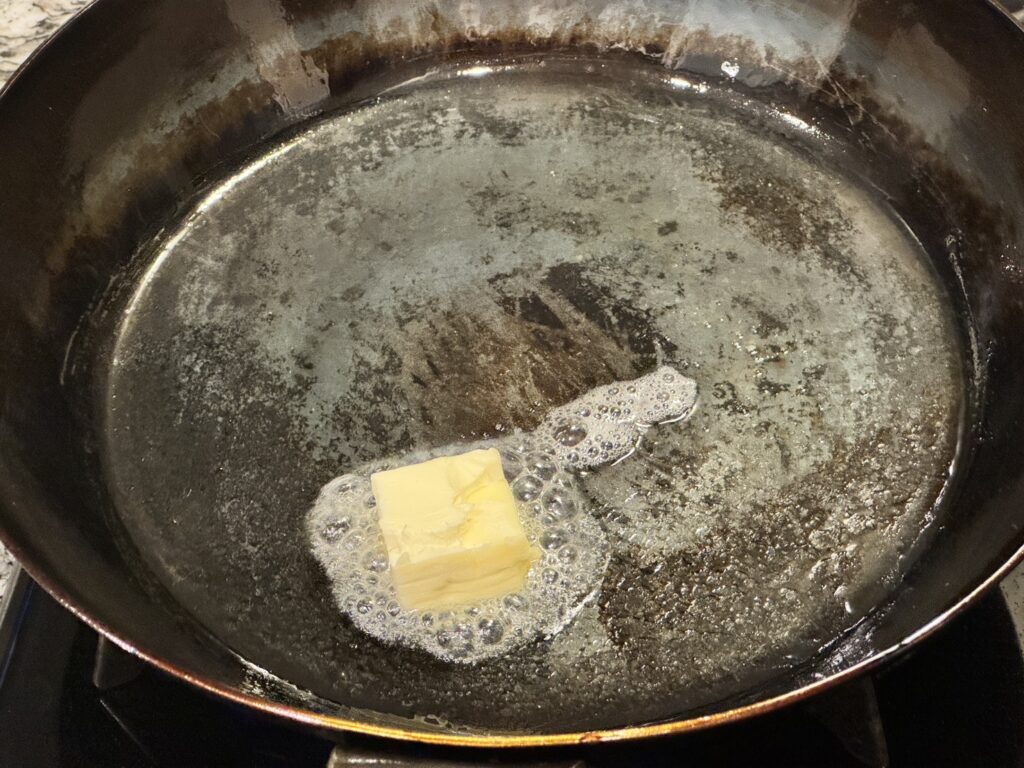 山田工業所の鉄フライパンにバター15グラムを入れている様子